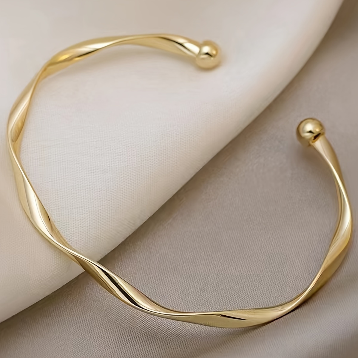 A Minimalist Adjustable Open Bangle for Women with a Twisted Design.